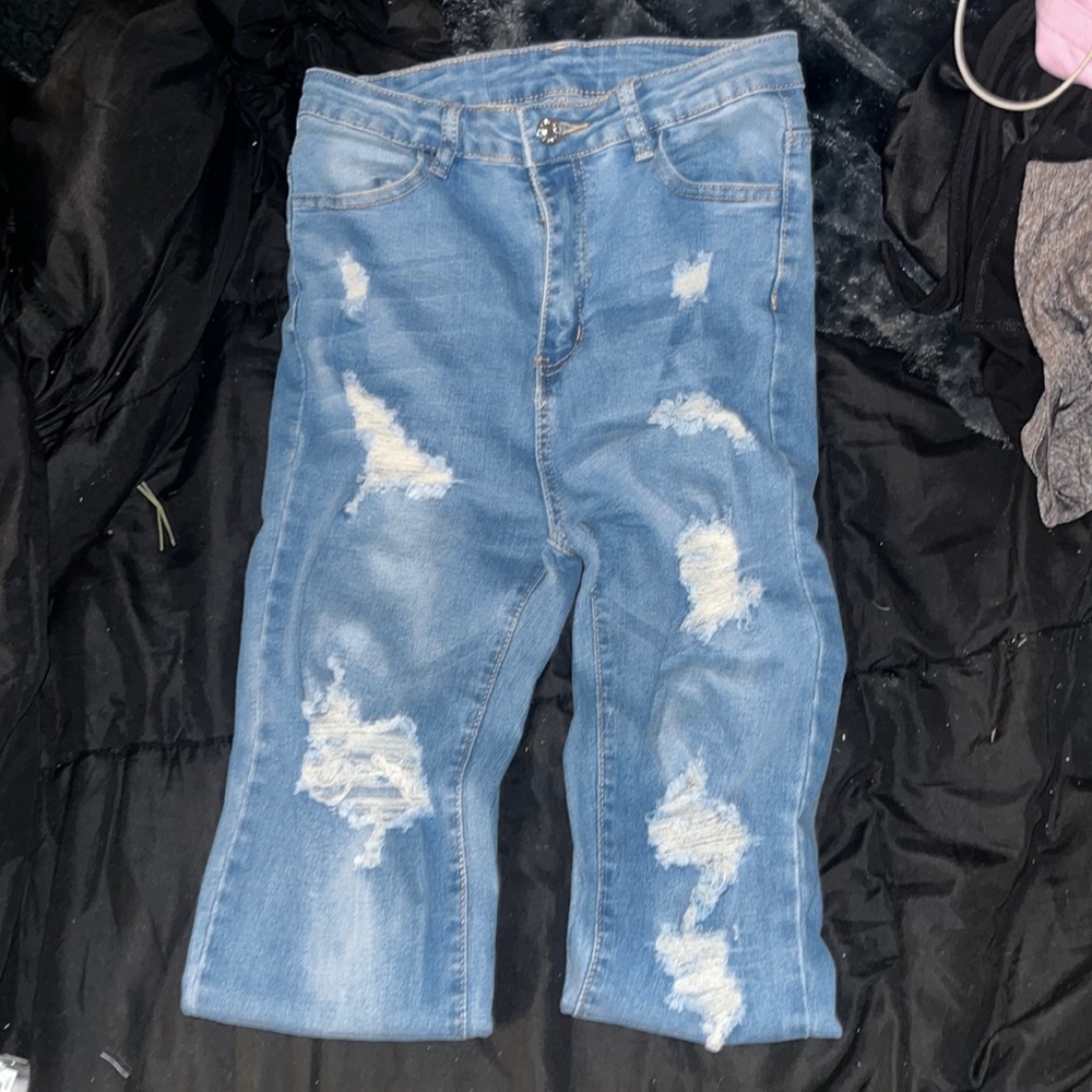 Light wash ripped blue jeans